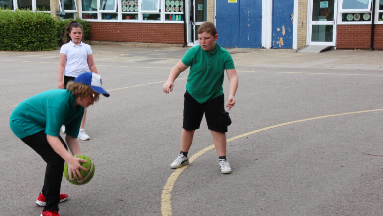 Pupils playing sport on the playground.